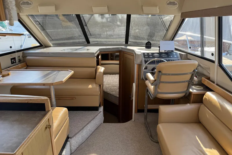 Slide: The Image of 2001 Bayliner 4087 Aft Cabin Motoryacht interior with helm, seating, and dining area. - 10