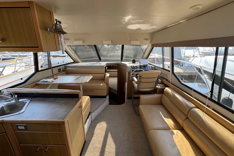 Slide: The Image of Interior of 2001 Bayliner 4087 Aft Cabin Motoryacht with seating, helm, and kitchenette. - 11