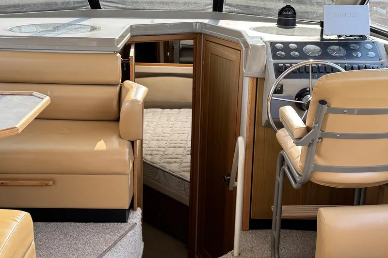 Slide: The Image of 2001 Bayliner 4087 Aft Cabin Motoryacht interior with helm, seating, and cabin view. - 12