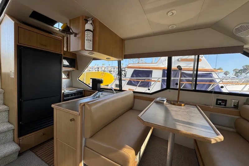 Slide: The Image of Interior of 2001 Bayliner 4087 Aft Cabin Motoryacht with dining area and kitchenette. - 13