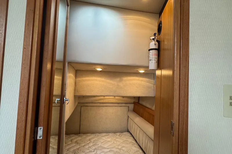 Slide: The Image of 2001 Bayliner 4087 Aft Cabin Motoryacht interior with cozy bed and fire extinguisher. - 15