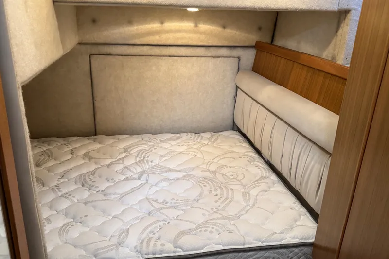 Slide: The Image of 2001 Bayliner 4087 Aft Cabin Motoryacht interior cabin with mattress and wood paneling. - 17