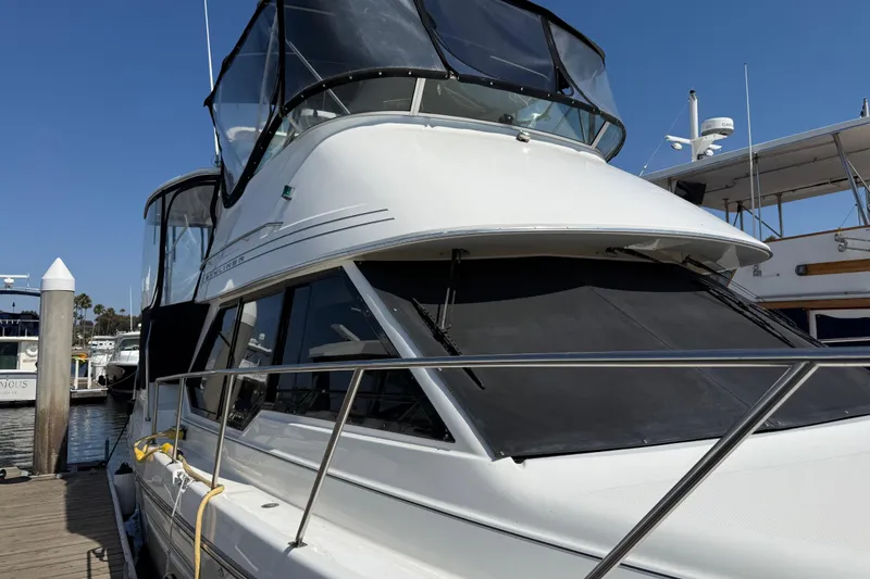 Slide: The Image of 2001 Bayliner 4087 Aft Cabin Motoryacht docked at marina under clear blue sky. - 2