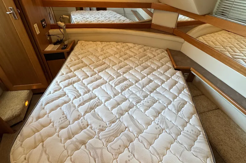 Slide: The Image of 2001 Bayliner 4087 Aft Cabin Motoryacht bedroom with a comfortable mattress and wooden accents. - 21