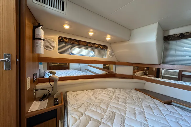 Slide: The Image of 2001 Bayliner 4087 Aft Cabin Motoryacht interior with cozy bed and wooden accents. - 23