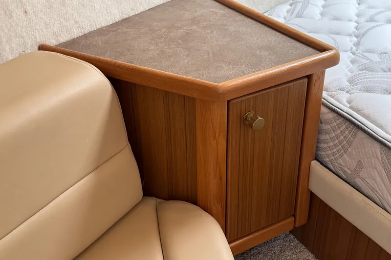 Slide: The Image of 2001 Bayliner 4087 Aft Cabin Motoryacht interior with wooden cabinet and beige seating. - 25