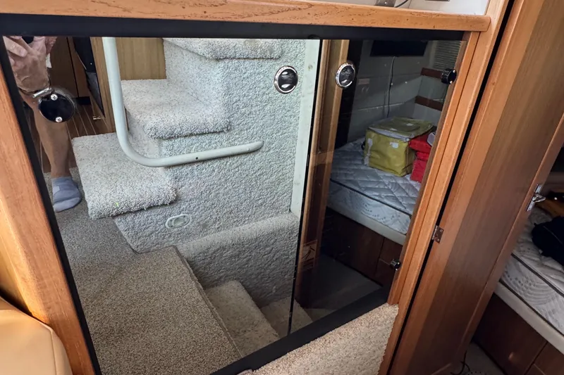 Slide: The Image of Interior of 2001 Bayliner 4087 Aft Cabin Motoryacht with carpeted stairs and cozy cabin. - 26