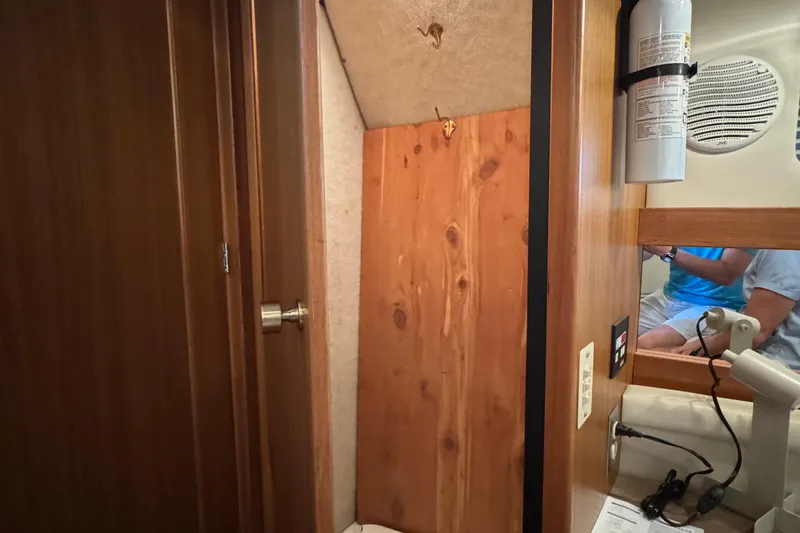 Slide: The Image of Interior of 2001 Bayliner 4087 Aft Cabin Motoryacht with wooden paneling and fire extinguisher. - 28