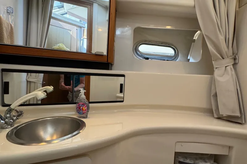 Slide: The Image of Bathroom interior of 2001 Bayliner 4087 Aft Cabin Motoryacht with sink and mirror. - 29