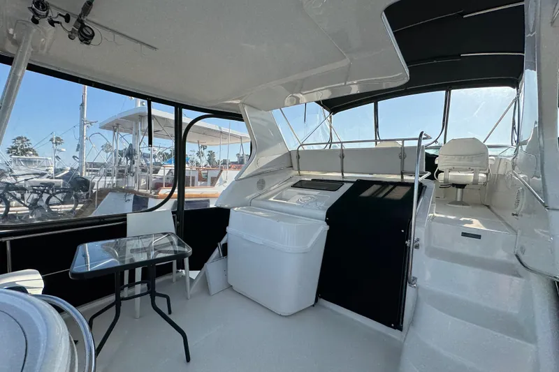 Slide: The Image of 2001 Bayliner 4087 Aft Cabin Motoryacht interior with seating and table, showcasing spacious design. - 32