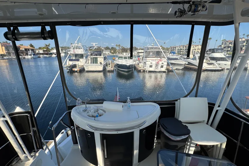 Slide: The Image of 2001 Bayliner 4087 Aft Cabin Motoryacht interior with marina view and seating area. - 33