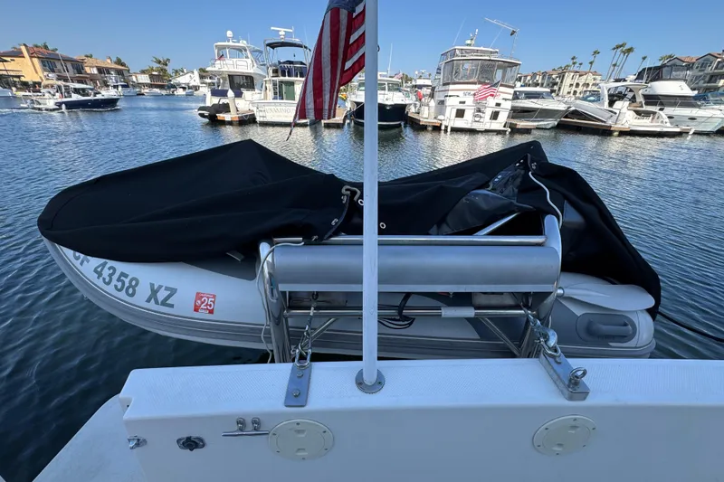 Slide: The Image of 2001 Bayliner 4087 Aft Cabin Motoryacht with covered dinghy in marina setting. - 38