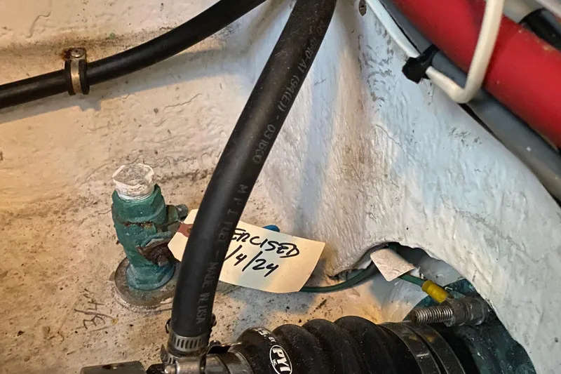 Slide: The Image of Engine compartment of 2001 Bayliner 4087 Aft Cabin Motoryacht with hoses and maintenance tag. - 40