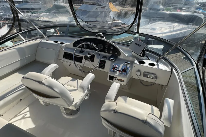 Slide: The Image of 2001 Bayliner 4087 Aft Cabin Motoryacht helm with dual seats and navigation equipment. - 46