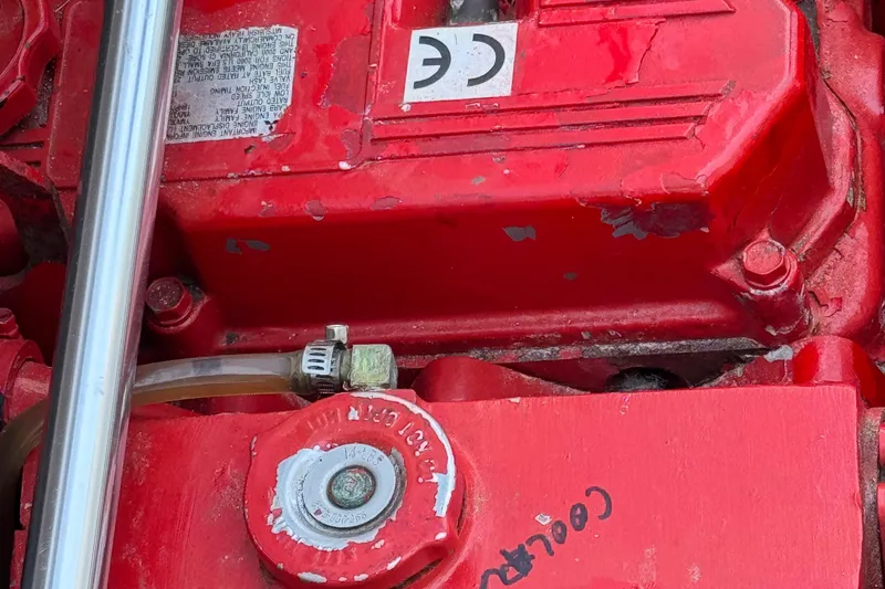 Slide: The Image of Engine component of 2001 Bayliner 4087 Aft Cabin Motoryacht, featuring red casing and metal pipe. - 47