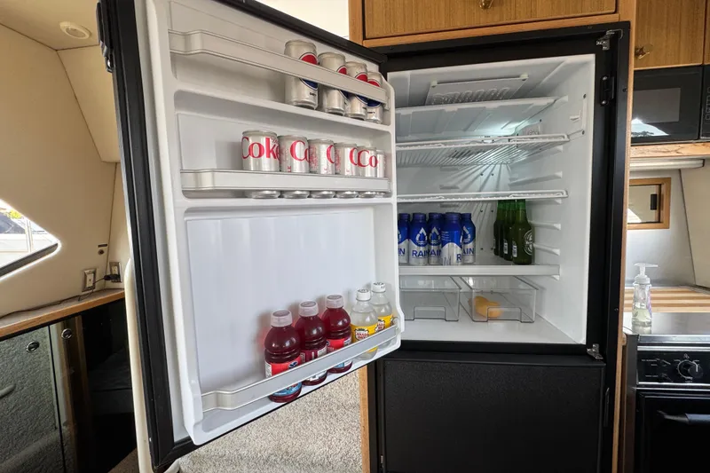 Slide: The Image of Open refrigerator in 2001 Bayliner 4087 Aft Cabin Motoryacht, stocked with beverages and snacks. - 49