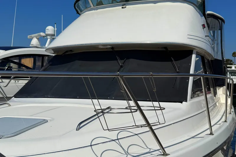 Slide: The Image of 2001 Bayliner 4087 Aft Cabin Motoryacht with sleek design and sunshade, docked in marina. - 52
