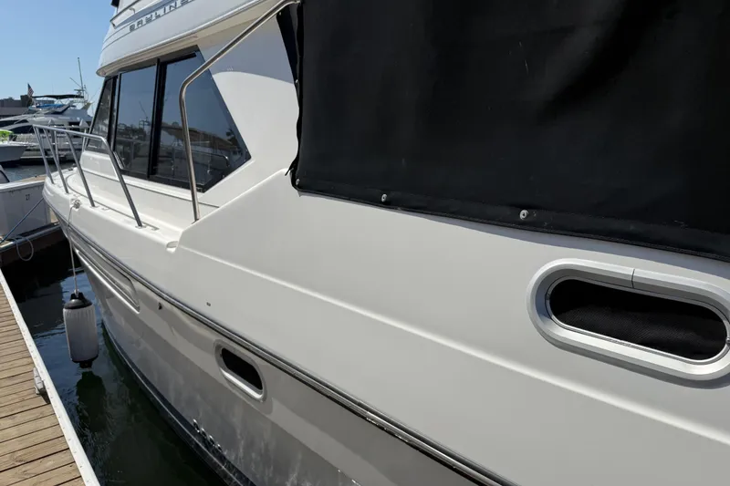 Slide: The Image of 2001 Bayliner 4087 Aft Cabin Motoryacht docked, side view with black cover. - 54