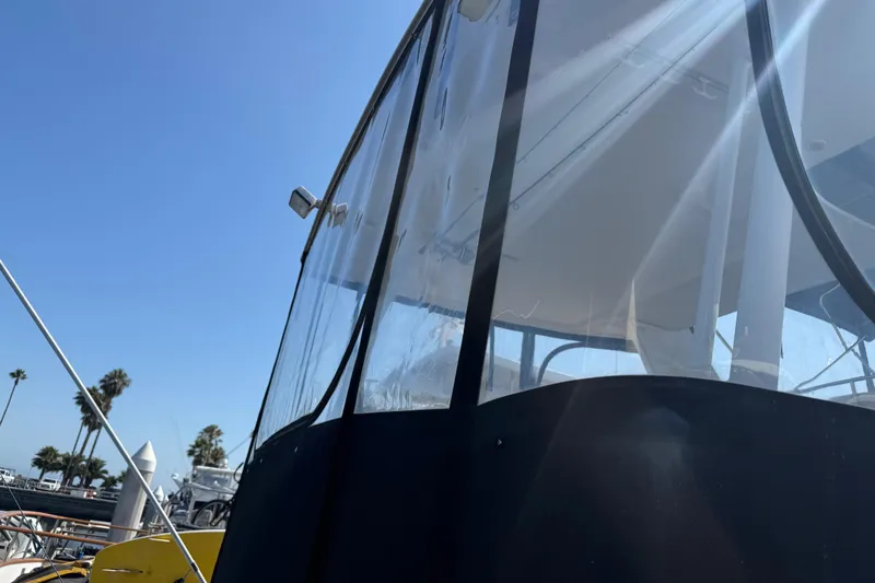 Slide: The Image of 2001 Bayliner 4087 Aft Cabin Motoryacht with clear enclosure under sunny sky. - 56