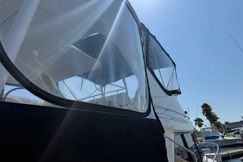 Slide: The Image of 2001 Bayliner 4087 Aft Cabin Motoryacht under clear blue sky at marina. - 57