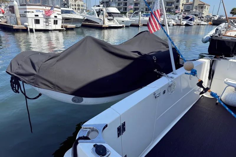 Slide: The Image of 2001 Bayliner 4087 Aft Cabin Motoryacht docked with covered dinghy and American flag. - 60