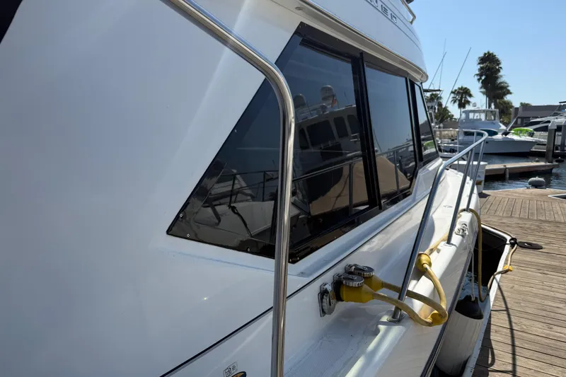 Slide: The Image of 2001 Bayliner 4087 Aft Cabin Motoryacht docked at marina, side view. - 61
