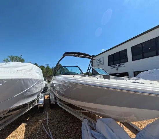 Slide: The Image of Chaparral 23 SSi OB 2026 boat with trailer outside store. - 5