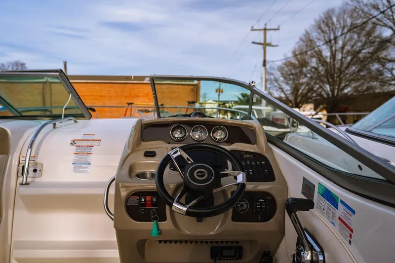 Slide: The Image of 2018 Chaparral 270 Signature boat dashboard with steering wheel and gauges. - 2