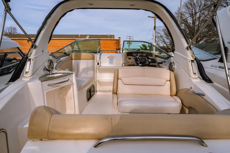 Slide: The Image of 2018 Chaparral 270 Signature boat interior with beige seating and modern dashboard. - 6