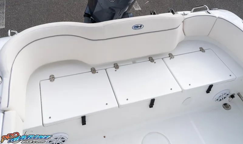 Slide: The Image of 2025 Sea Hunt Ultra 229 boat interior with white seating and storage compartments. - 12