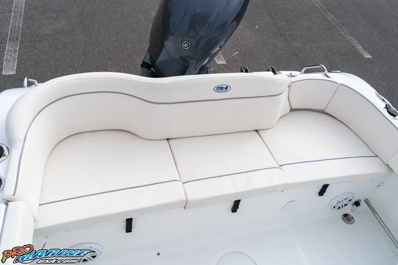 Slide: The Image of 2025 Sea Hunt Ultra 229 boat with white cushioned seating and Yamaha outboard motor. - 14