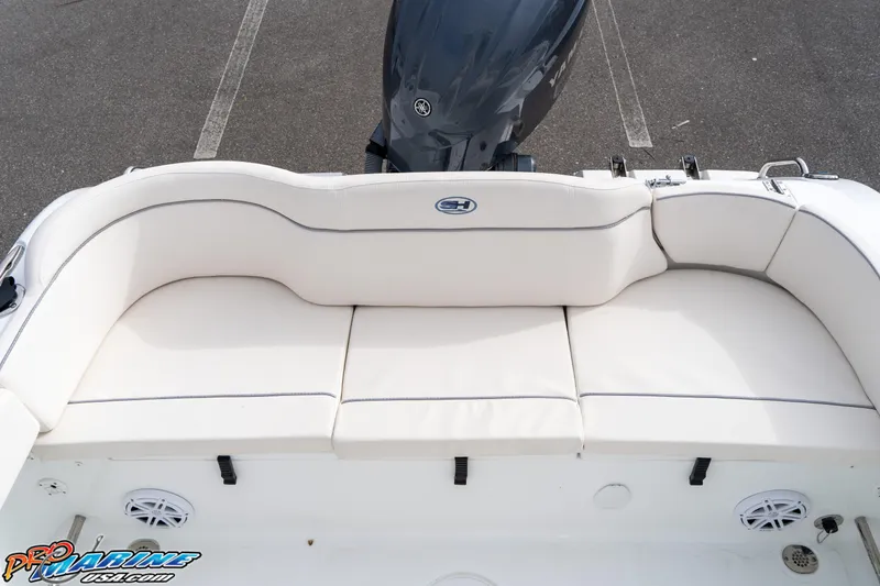Slide: The Image of 2025 Sea Hunt Ultra 229 boat with white seating and Yamaha outboard motor. - 15