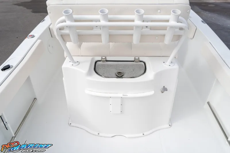 Slide: The Image of 2025 Sea Hunt Ultra 229 boat interior with rod holders and storage compartment. - 16