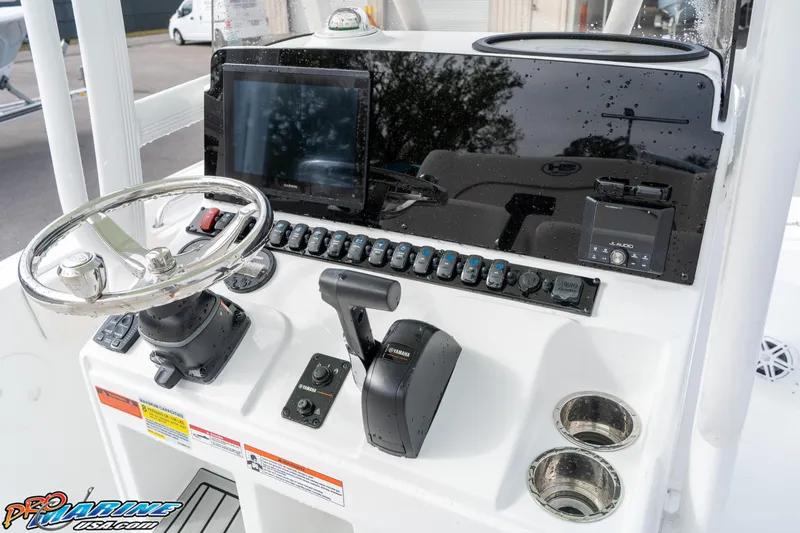 Slide: The Image of 2025 Sea Hunt Ultra 229 boat dashboard with steering wheel, controls, and electronic displays. - 19