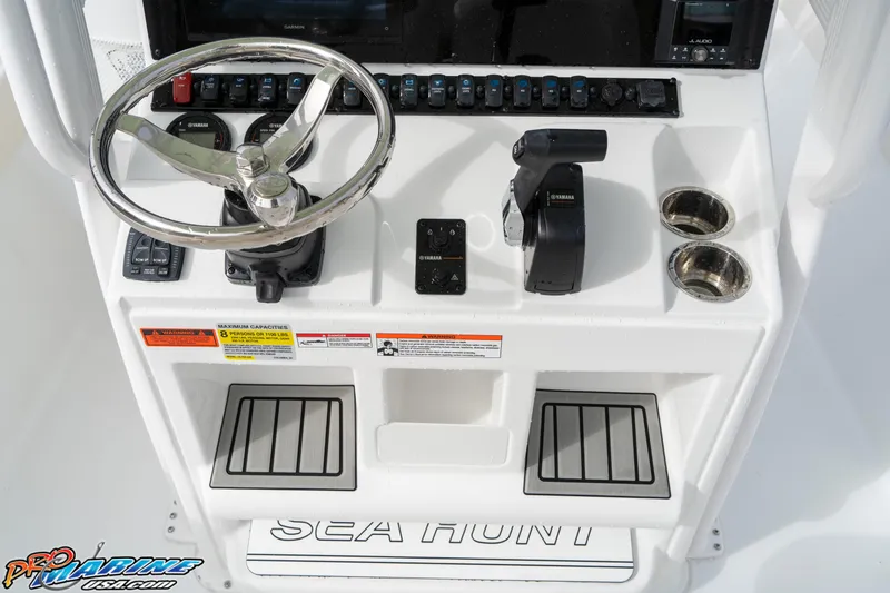 Slide: The Image of 2025 Sea Hunt Ultra 229 boat console with steering wheel and controls. - 21