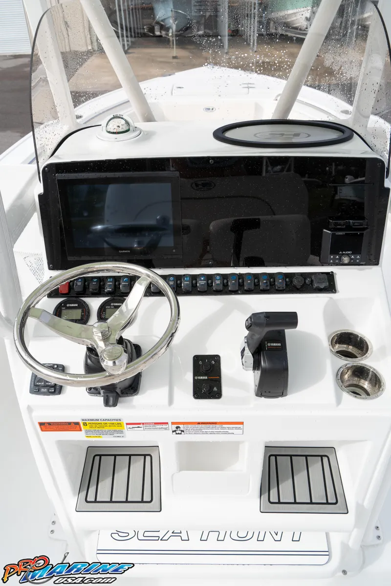 Slide: The Image of 2025 Sea Hunt Ultra 229 boat console with steering wheel and controls. - 22