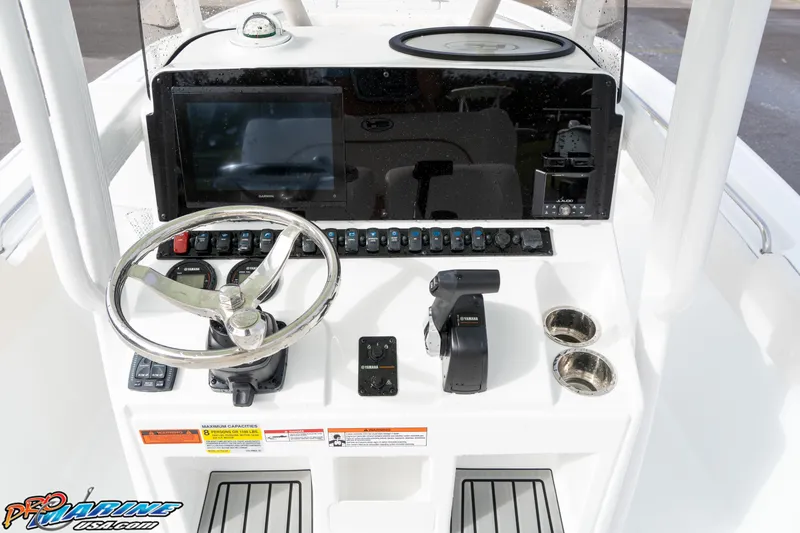Slide: The Image of 2025 Sea Hunt Ultra 229 boat dashboard with steering wheel and control panel. - 23