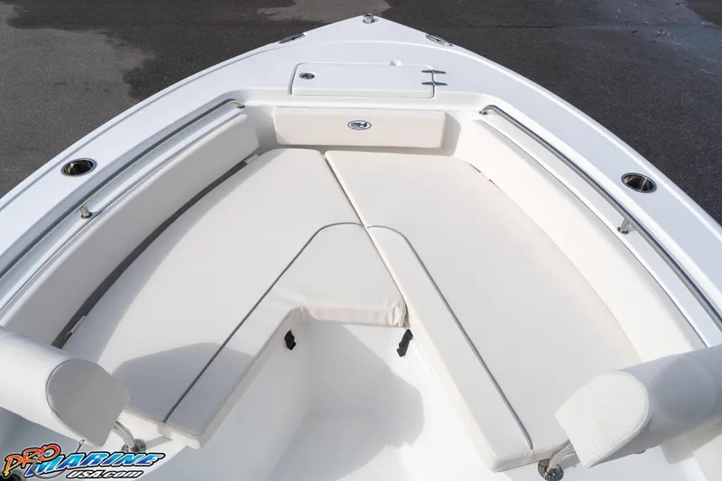 Slide: The Image of 2025 Sea Hunt Ultra 229 boat interior with cushioned seating and storage. - 7