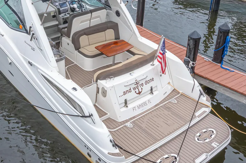Slide: The Image of 2014 Sea Ray 330 Sundancer docked, featuring spacious deck and seating, Fort Myers, FL. - 2