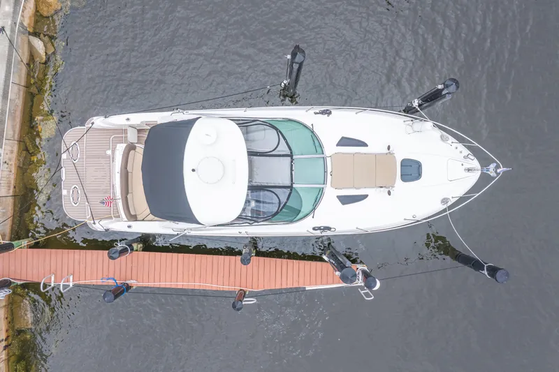 Slide: The Image of Overhead view of a 2014 Sea Ray 330 Sundancer docked at a wooden pier. - 3