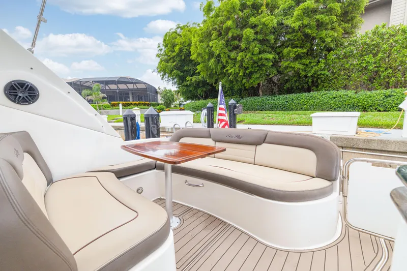 Slide: The Image of Luxurious 2014 Sea Ray 330 Sundancer yacht with elegant seating and wooden table. - 6