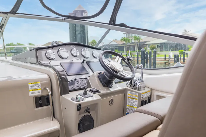Slide: The Image of Cockpit of 2014 Sea Ray 330 Sundancer with steering wheel and control panel. - 7