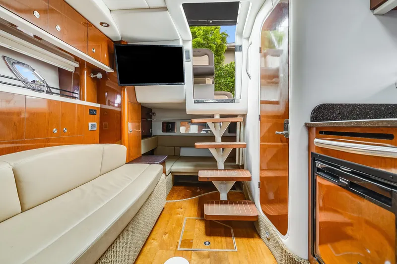 Slide: The Image of Luxurious interior of 2014 Sea Ray 330 Sundancer yacht with modern amenities and wooden finishes. - 9