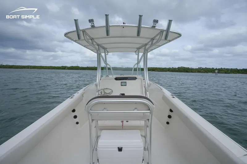 Slide: The Image of 2024 Sailfish 242 CC boat on open water under cloudy skies. - 7