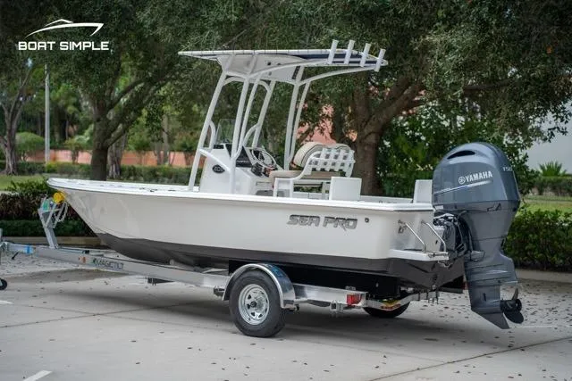 Slide: The Image of 2024 Sea Pro 208 Bay boat on trailer with Yamaha engine, parked outdoors. - 5