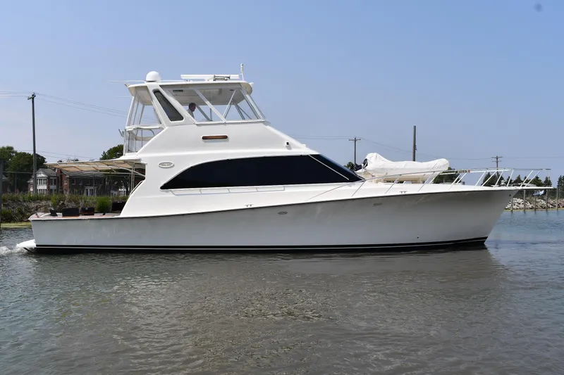 The Image of 1996 Ocean Yachts 53 Super Sport cruising on calm waters, side view. - 1