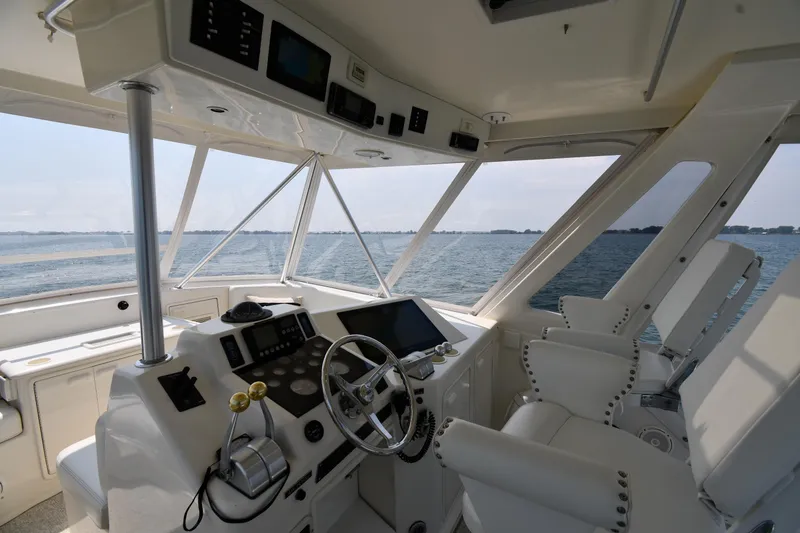 Slide: The Image of Interior helm of 1996 Ocean Yachts 53 Super Sport, featuring modern controls and ocean view. - 12