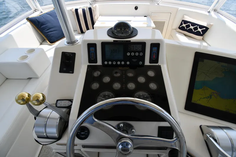 Slide: The Image of Cockpit of 1996 Ocean Yachts 53 Super Sport with navigation instruments and steering wheel. - 13