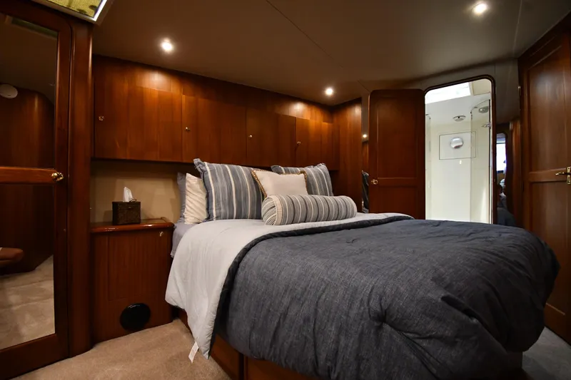 Slide: The Image of Luxurious bedroom interior of 1996 Ocean Yachts 53 Super Sport with elegant wood paneling. - 27