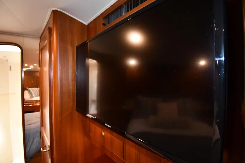 Slide: The Image of Interior of 1996 Ocean Yachts 53 Super Sport with mounted TV and wood paneling. - 32